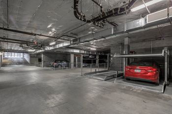 A red car parked in a parking garage